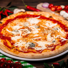 Pizza Quattro formaggi on wooden table
