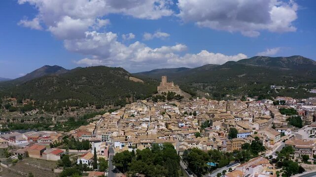 Aerial view of the town of Biar and its defensive castle in a mountain peak in the city center, in Alicante, Spain.