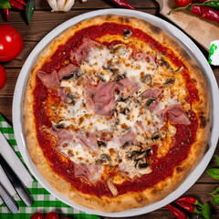Pizza capricciosa with cooked ham, mozzarella on wooden table