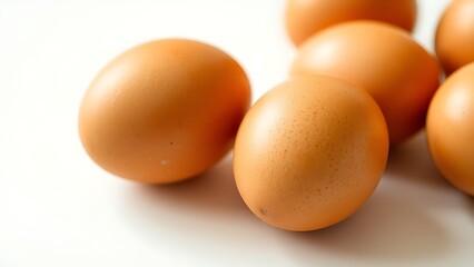Fresh brown eggs on white surface, highlighting natural texture and simplicity.