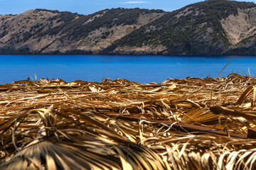 Paradise Beach on the island of Rab in Croatia in Lopar, straw umbrella, no people