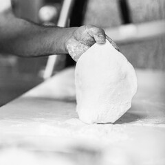 Chef's hands spraying flour over the dough. Kneading dough. chef kitchen dough