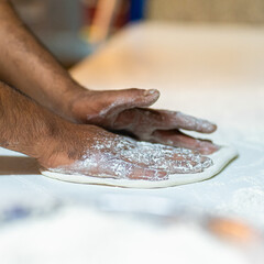 Chef's hands spraying flour over the dough. Kneading dough. chef kitchen dough