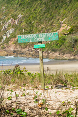 Florianopolis, Brazil - August, 29th 2025: Sign stating that deforesting the Restinga forest is a crime at Praia da Solidao