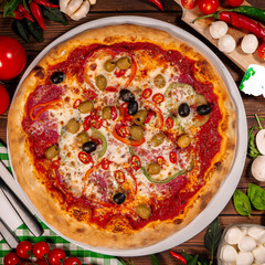 Pizza Diablo Diavolo hot chili peppers on a wooden background top view.