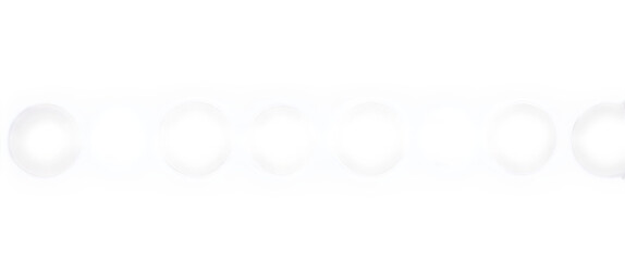 Abstract pattern of bright white oval bokeh lights against a dark black background