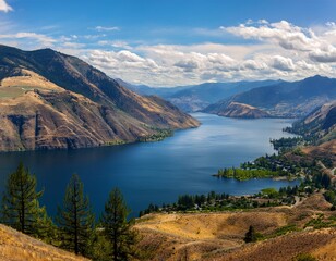 Naklejka premium scenic panorama of lake chelan washington state usa from high angle view with mountains and clouds on a sunny day in the pacific northwest