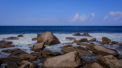 beach view with piles of coral rocks