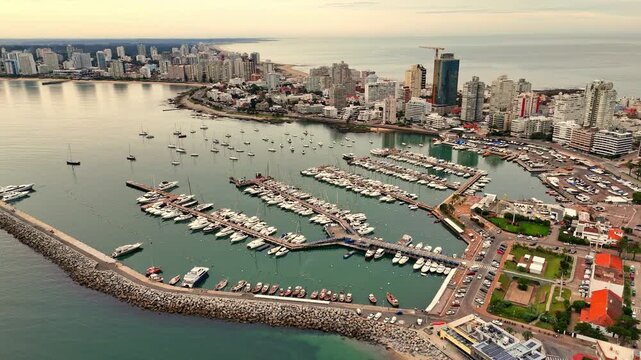 Orbiting aerial footage of Punta del Este Port at sunset in Punta del Este city, Maldonado, Uruguay