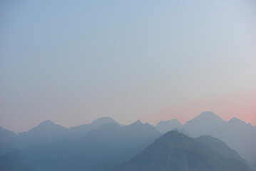silhouette of mountains at sunset, blue blurred natural background