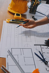 Construction and structure concept of engineer working drawing on blueprint meeting for project...