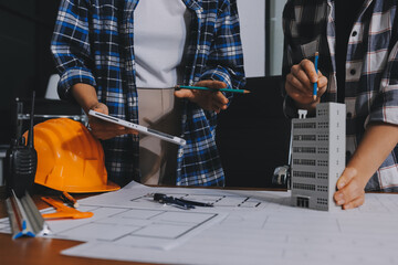 Construction and structure concept of engineer working drawing on blueprint meeting for project...