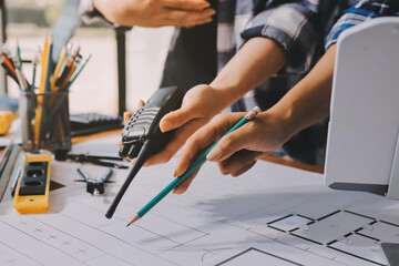 Construction and structure concept of engineer working drawing on blueprint meeting for project...