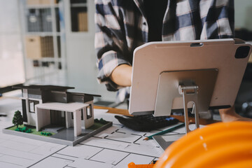 Construction and structure concept of engineer working drawing on blueprint meeting for project...