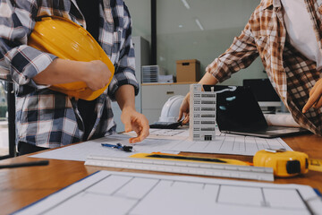 Construction and structure concept of engineer working drawing on blueprint meeting for project...