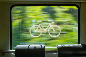 Bike sticker or decal on the window of a train in Europe. Points the designated space for bike...