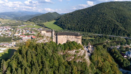 Orava Castle perched on dramatic cliffs above the Orava River in Slovakia. Sunset light reveals medieval architecture and breathtaking landscape. Ideal for history and travel visuals