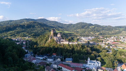 Orava Castle perched on dramatic cliffs above the Orava River in Slovakia. Sunset light reveals medieval architecture and breathtaking landscape. Ideal for history and travel visuals