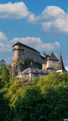 Orava Castle perched on dramatic cliffs above the Orava River in Slovakia. Sunset light reveals medieval architecture and breathtaking landscape. Ideal for history and travel visuals