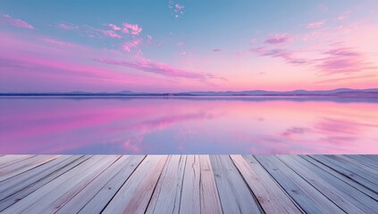 Peaceful pink sunrise over a calm lake, with a wooden platform