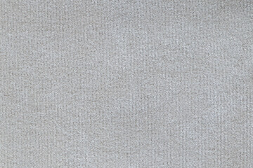 Light brown or beige fine knit fabric that can be used as a background, pattern, texture or wallpaper