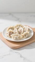 Plate of dumplings on cutting board