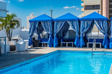 Hotel rooftop swimming pool and cabanas.