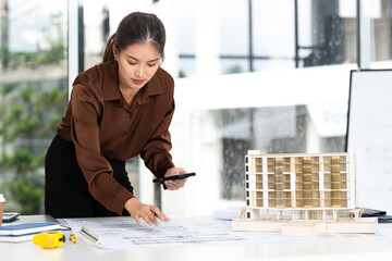 Female Civil Engineer Construction professional reviewing shop drawing of structural floor plan.