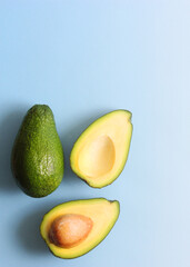 Ripe avocado close-up on a colored background. Vertical photo format