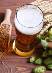 Beer, wheat and hops on the table.. Vertical photo format