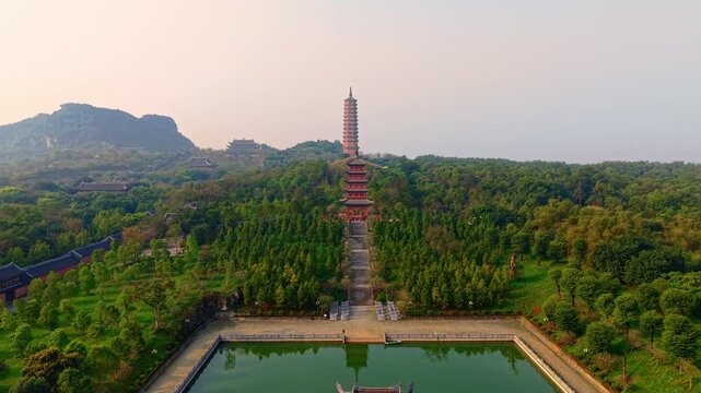 Aerial view of bai dinh pagoda in lush Ninh Binh landscape under blue sky.