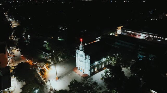 Aerial night view of the Nagaraja Temple glowing under warm streetlights and quiet roads