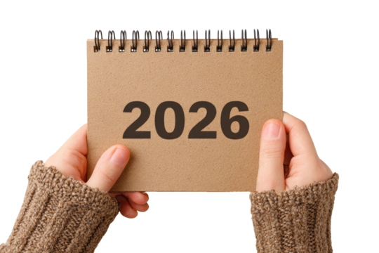 Hands holding a kraft paper calendar with the year 2026 displayed