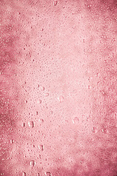 beautiful background background dense with water drops on glass and stains, delicate feminine pink berry delicate pastel color and shade, faded, discolored for girls and girls