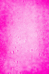 beautiful background background dense with water drops on glass and stains, gentle feminine pink bright neon color and shade for girls and young women