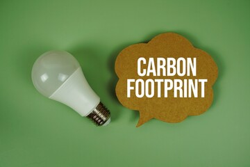 Carbon Footprint text with light bulb on green background
