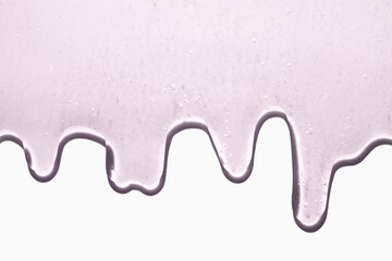 Liquid glowing luminous pink gel or serum on neutral light  gray background. Beauty product sample swatch