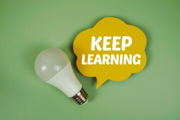 Keep Learning text with light bulb on green background