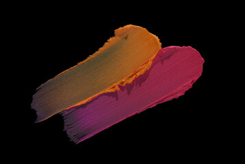 Beauty product sample lipstick isolated on black background. Two shades. Orange and pink fuchsia colored. Make up swatch