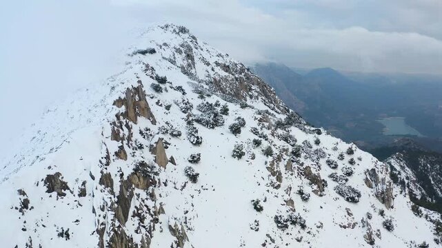 Aerial view of heavy snowfall over the mountains of the village of Castell de Castells in the province of Alicante, Spain.