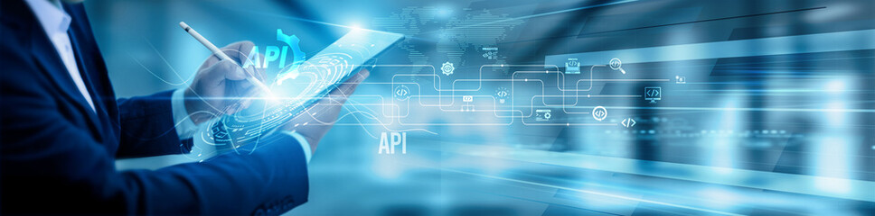 The API developer team is using a tablet and analyzing API integrations, data exchange endpoint...