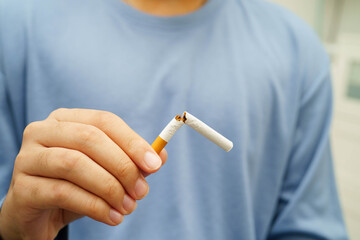 Quit smoking, Asian man breaking destroy cigarette in hand.