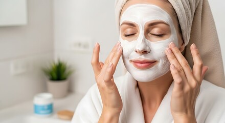 Beautiful Woman Applying White Cosmetic Face Mask for Skin Rejuvenation Spa Treatment and Self Care Routine in Bathroom