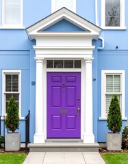 A vibrant purple front door stands out against a light blue house facade, framed by white trim and columns, creating a cheerful and inviting entrance.