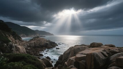Obraz premium Dramatic coastal scene with sunlight piercing through storm clouds over rocky shores and calm sea