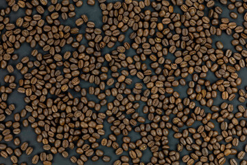 Roasted coffee beans background. Aromatic brown texture for cafe menu, wallpaper, or design. Top view.