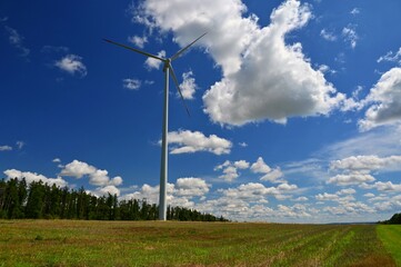 Wind power plant on meadow. Concept for energy, technology and green power with clean environment.