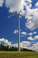 Wind power plant on meadow. Concept for energy, technology and green power with clean environment.