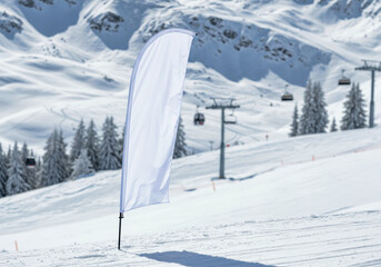 Fototapeta premium Teardrop flag mockup blank white banner in the snow at a ski resort for a winter sports event