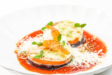 Baked eggplant and shrimp with tomato sauce and cheese. copy space